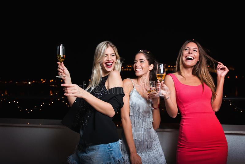 three beautiful cheerful women having girls night out fun happy smiling 107748902