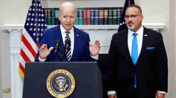 US President Joe Biden announces student loan debt relief with Education Secretary Miguel Cardona (R) on August 24, 2022, in the Roosevelt Room of the White House. (Photo: Forbes via Getty Images)