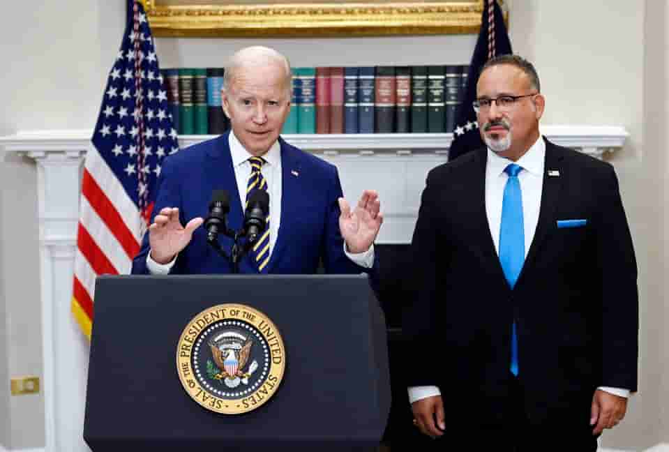 US President Joe Biden announces student loan debt relief with Education Secretary Miguel Cardona (R) on August 24, 2022, in the Roosevelt Room of the White House. (Photo: Forbes via Getty Images)