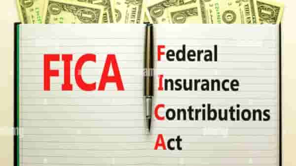 FICA symbol. Concept words FICA federal insurance contributions act on white note on beautiful white background. Dollar bills.