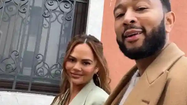 Teigen shared several snaps from her family’s trip to Venice, Italy, on Instagram Saturday, including one that showed Legend using a fuzzy swaddle to cradle their baby girl against his chest.